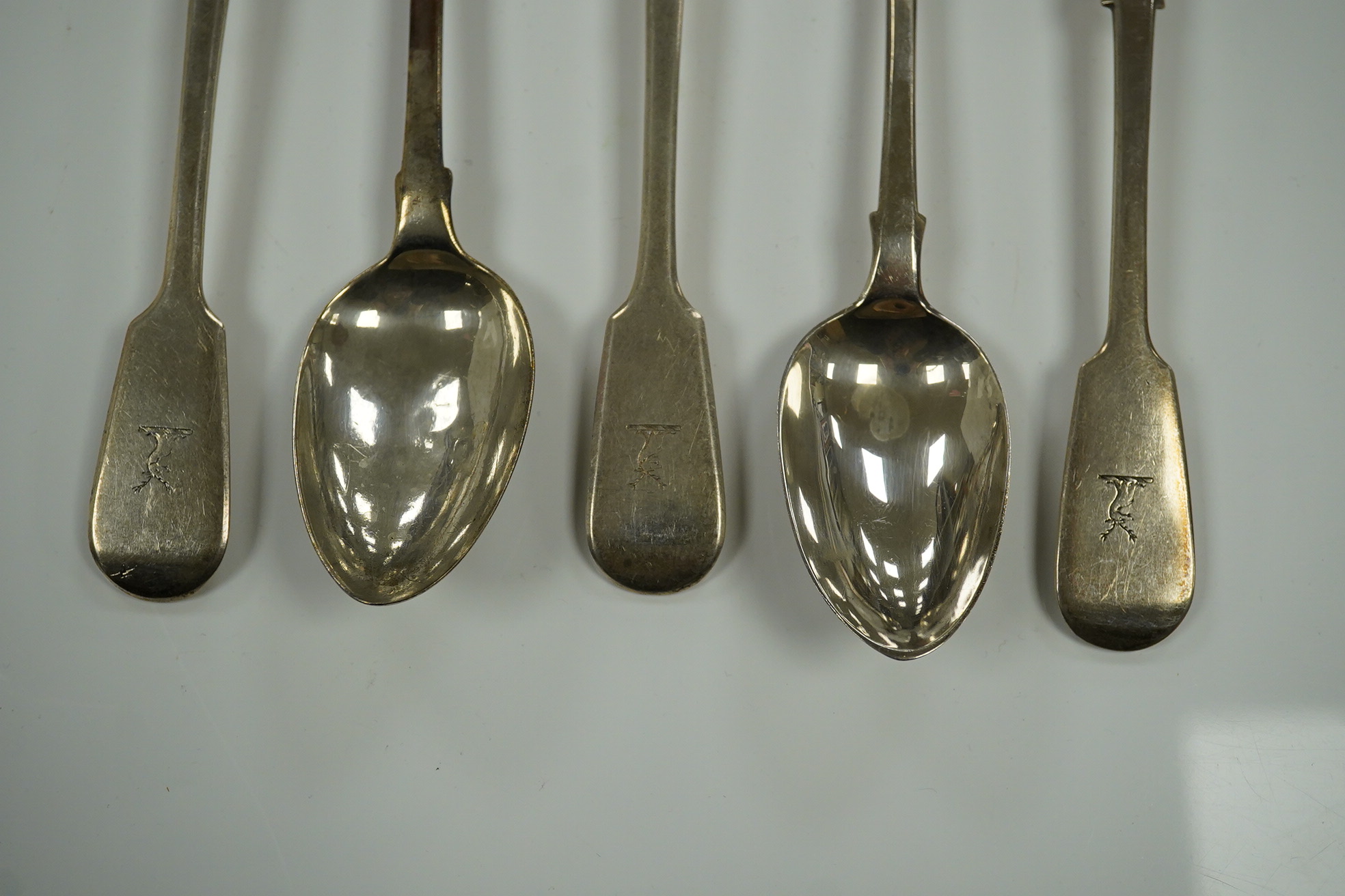 A harlequin set of twelve William IV/Victorian silver fiddle pattern dessert spoons, various date and makers, 17.7oz. Condition - poor to fair